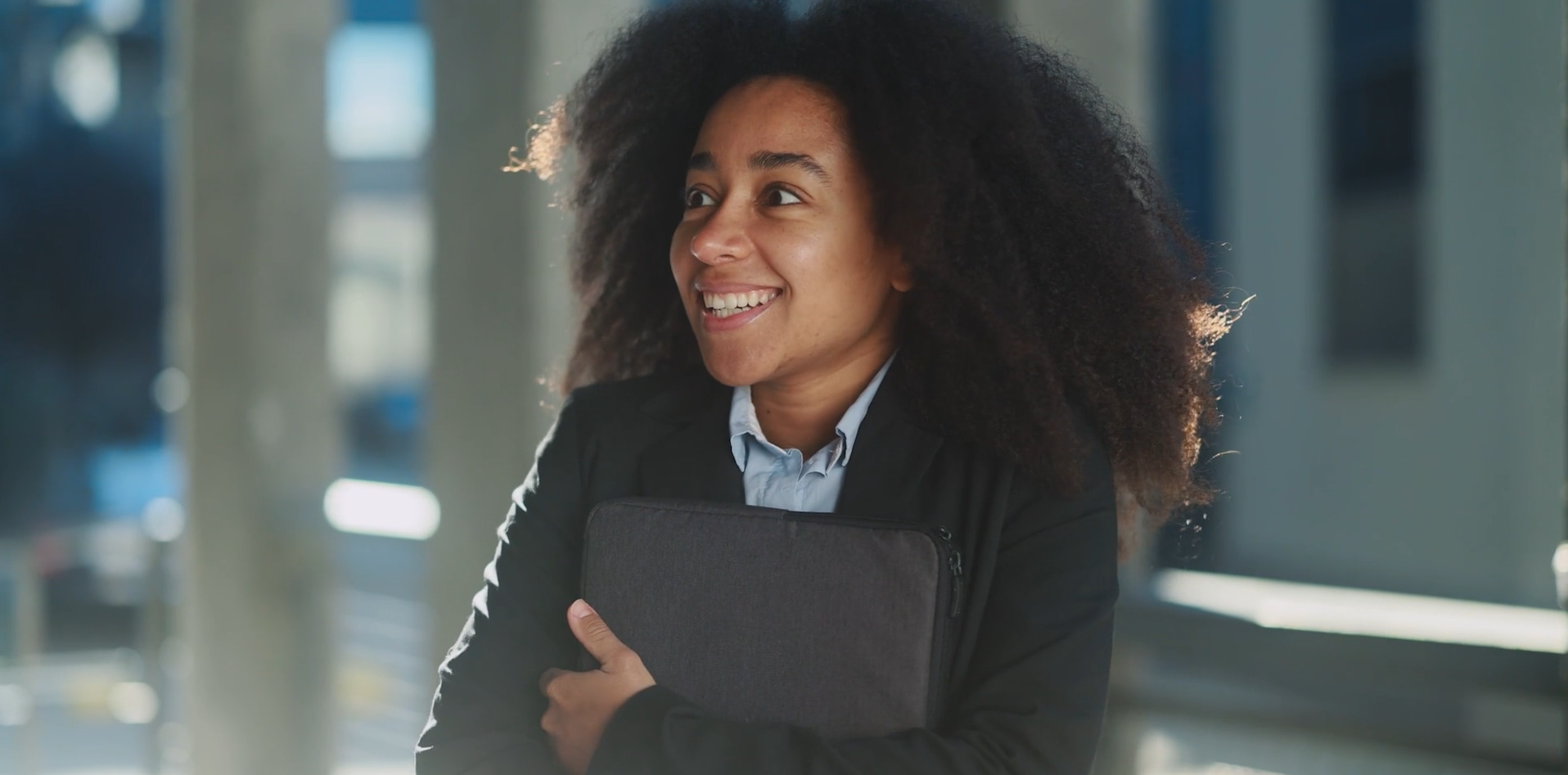 happy student clutching binder