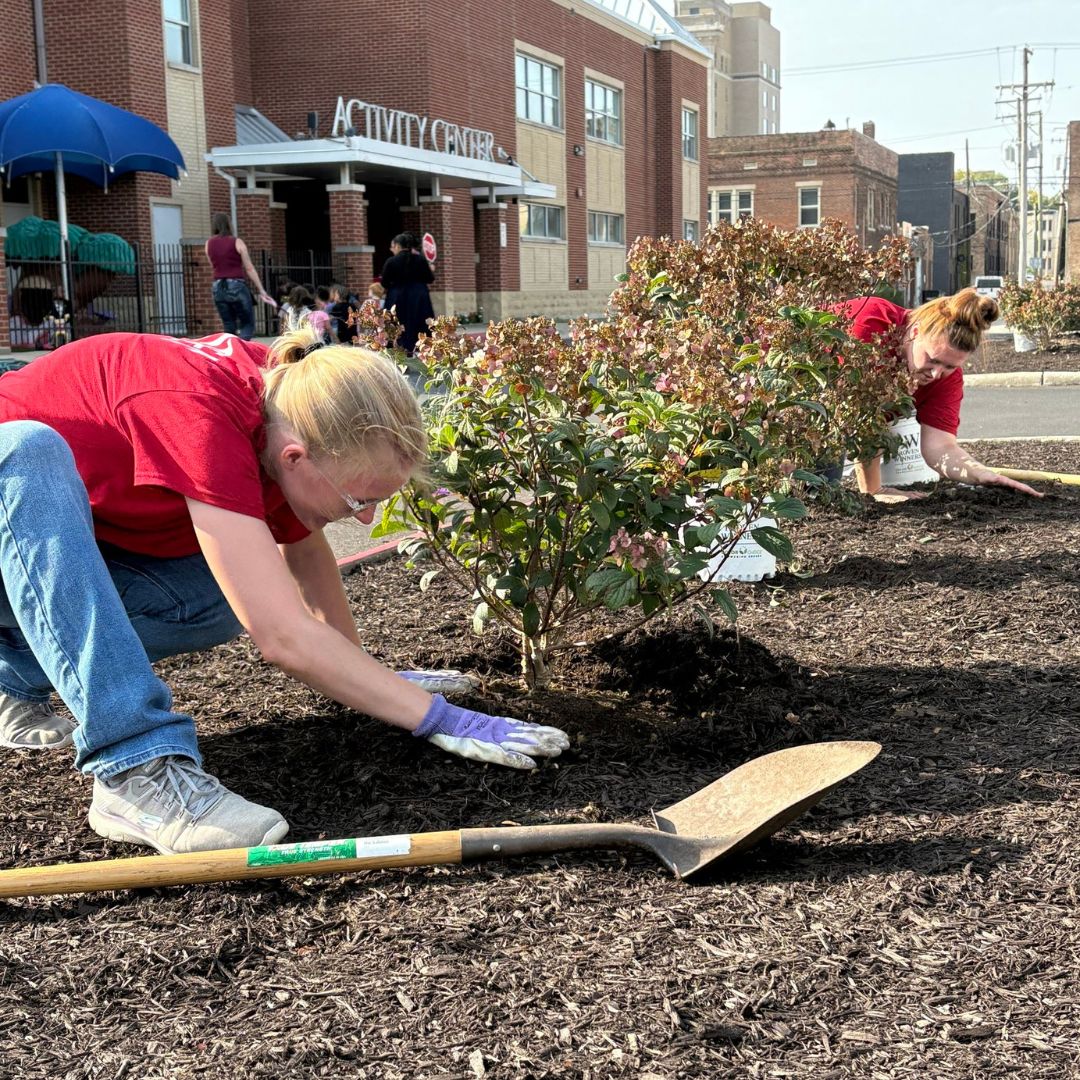 Group of United Way Rock River Valley Day of Caring volunteers standing together outdoors wearing red volunteer shirts.