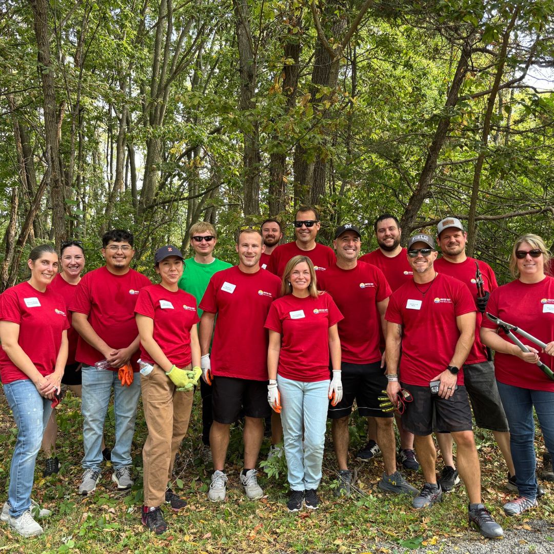 Two volunteers wearing hairnets and gloves preparing meals together during a United Way Rock River Valley Day of Caring project.