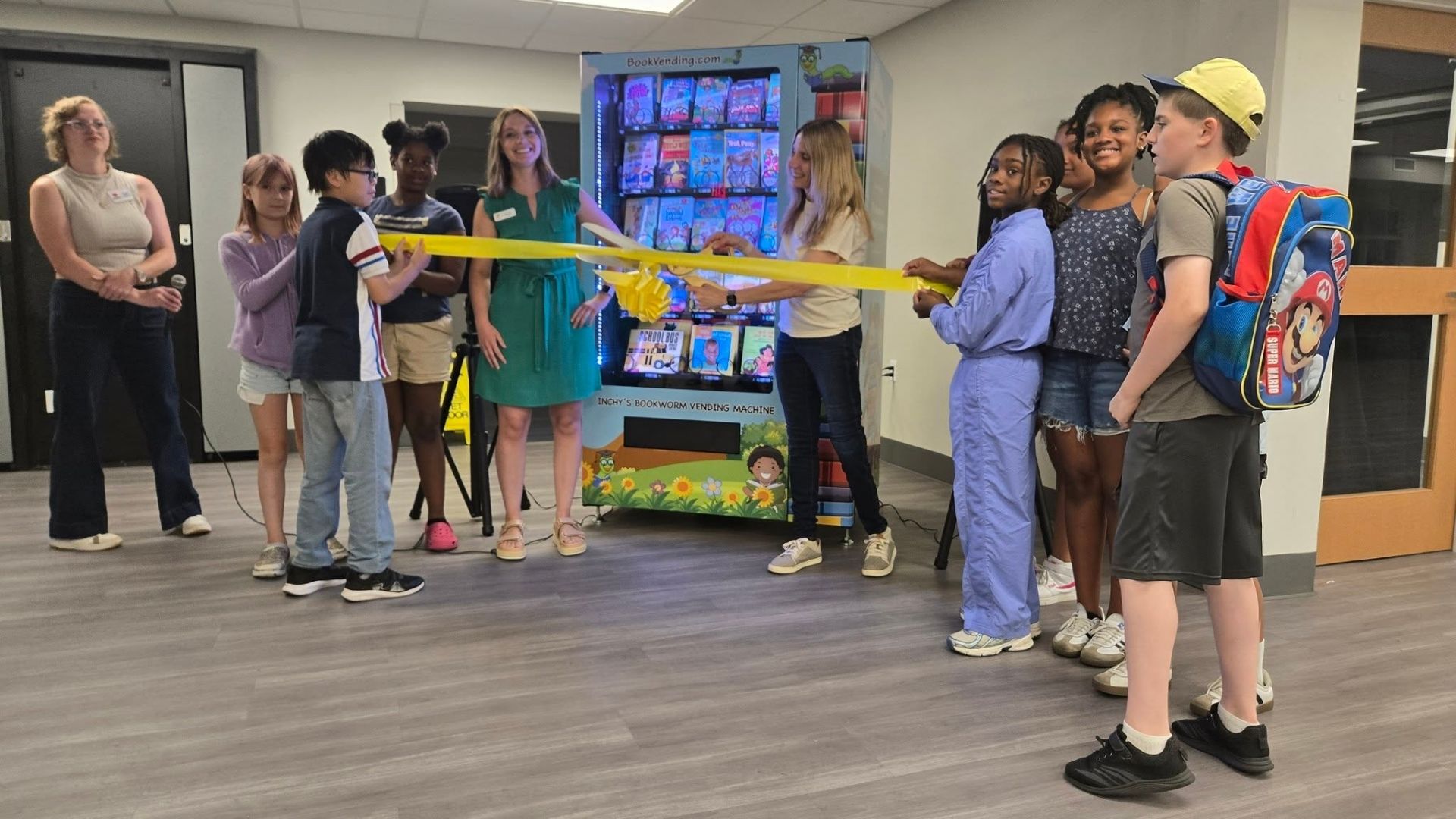 Ribbon cutting ceremony for the Bookworm Vending Machine at the Good Shepherd YMCA in Rockford, Illinois, hosted by the Junior League of Rockford.