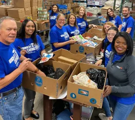Group of employees packing boxes during United Way Rock River Valley Day of Caring event