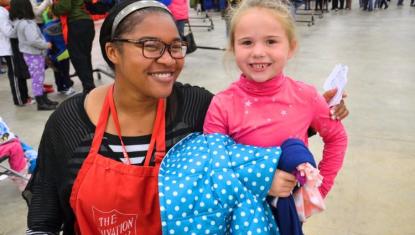 Little girl with Salvation Army volunteer